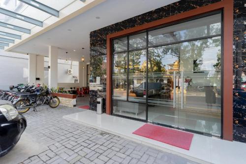 メダンにあるLexus Hotel Medanのガラス窓とバイクが駐車した店舗