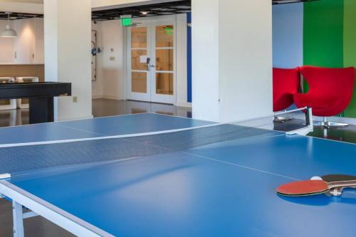 a ping pong table in a room with two chairs at *The Stunning *King Suite* Heart of Towson in Towson