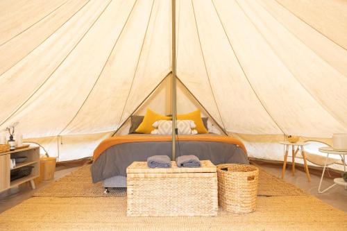 a bedroom with a bed in a tent at Coonamble Riverside Caravan Park in Coonamble