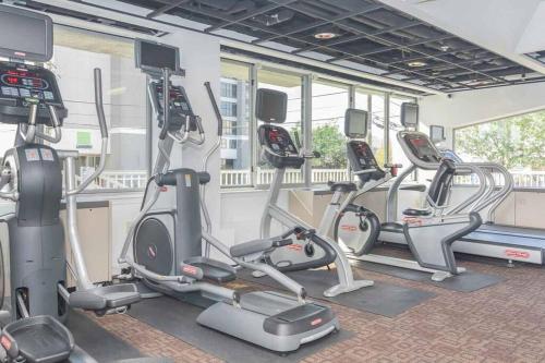 a gym with several cardio bikes and tread machines at *The Stunning *King Suite* Heart of Towson in Towson