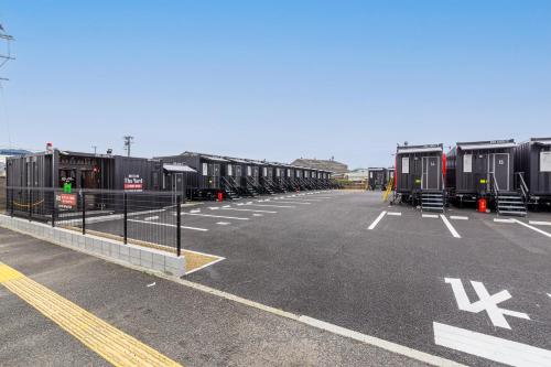 a parking lot with a row of train cars at HOTEL R9 The Yard 唐津 in Karatsu