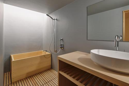 a bathroom with a white sink and a mirror at 別邸 仲乃家 in Tochigi