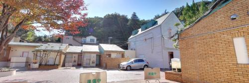 a small town with a white car parked in a parking lot at パリセーヌ in Mitake