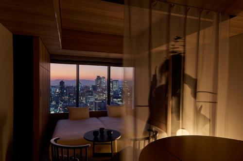 a room with a view of a city skyline at The Royal Park Hotel Iconic Nagoya in Nagoya