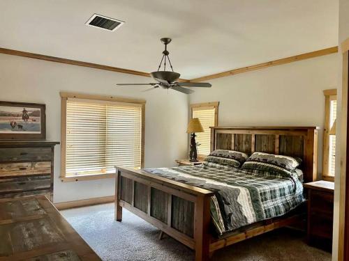 a bedroom with a bed and a ceiling fan at Wapiti Valley Magic, East Yellowstone in Wapiti