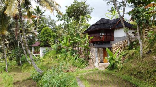 a house on the side of a hill at Nea Cottage Lombok in Tetebatu