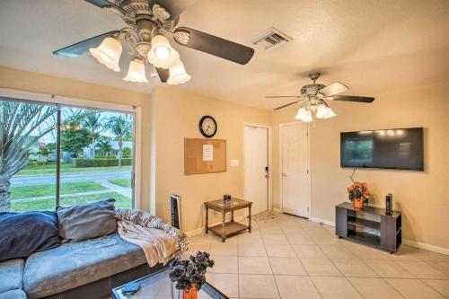 a living room with a couch and a flat screen tv at Palm Wave Says - Cozy - 2 Jacuzzis - Quiet Street in West Palm Beach