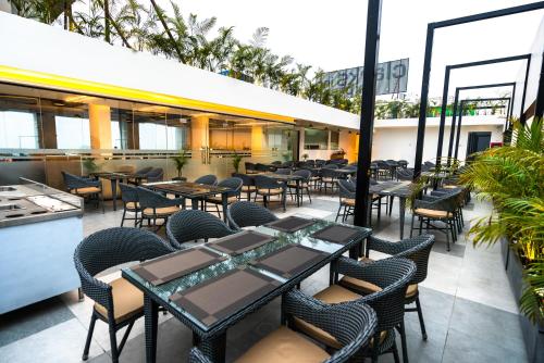 a restaurant with tables and chairs in a building at Clarks inn Express Ayodhya in Ayodhya