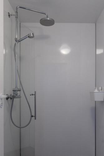a shower in a bathroom with a glass door at Vogar Travel Service in Myvatn