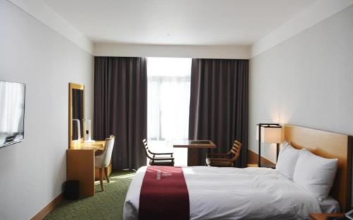 Ένα ή περισσότερα κρεβάτια σε δωμάτιο στο Hotel Laonzena