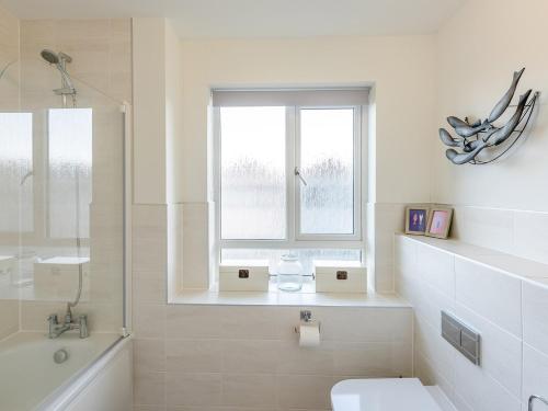 Northam的住宿－2 Bed in Westward Ho 35927，一间带卫生间、水槽和窗户的浴室