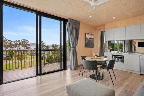 a kitchen and dining room with a table and chairs at Tasman Holiday Parks - St Helens in St Helens