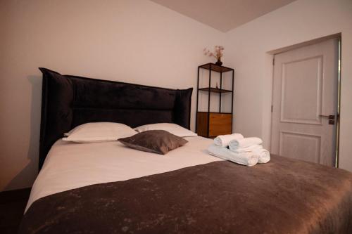 a bedroom with a bed with towels on it at Complex Omnia - Apartamente Husi in Huşi
