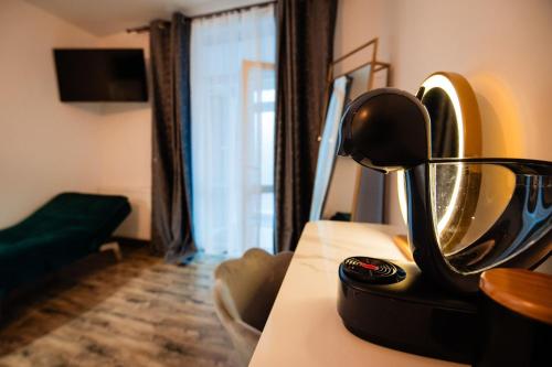 a mirror on a table in a room at Complex Omnia - Apartamente Husi in Huşi