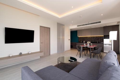 a living room with a couch and a table at Thaya Hotel Bangkok in Bangkok