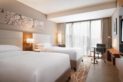 a hotel room with two beds and a desk at Courtyard by Marriott Seoul Pangyo in Seongnam