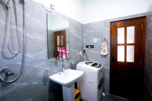 y baño con aseo, lavabo y ducha. en cric villa en Galle