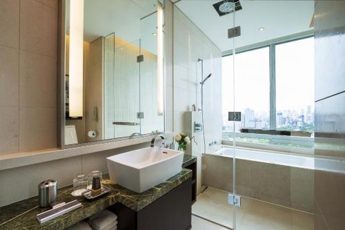 a bathroom with a sink and a large mirror at Marriott Executive Apartment Seoul in Seoul