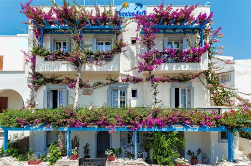 a building with flowers on the side of it at Sofi pension in Naxos Chora