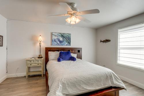a bedroom with a bed with a ceiling fan at Waterfront NOLA Gem with Boat Dock and Lift in Venetian Isles