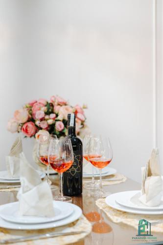 a table with wine glasses and a bottle of wine at Luxe Paradise Suite Hotel Trich Sai in Hanoi