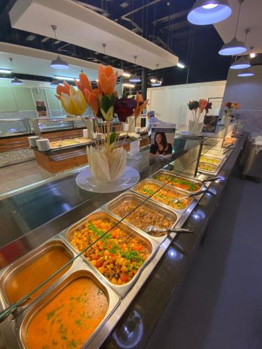 a buffet line with many different types of food at Birlik in Tengiz