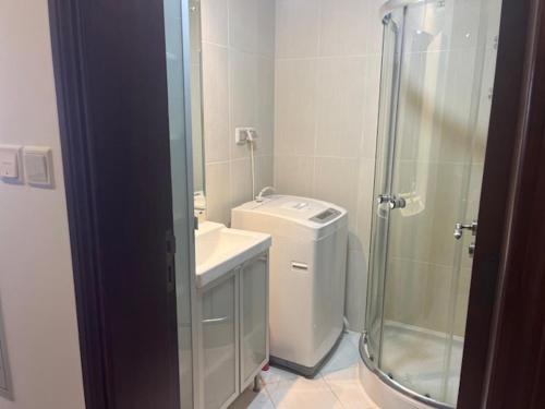 a bathroom with a shower and a toilet and a sink at Ocean Breeze in Ras al Khaimah