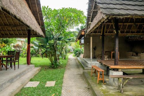 an outside of a building with a table and chairs at Bali Village Villa in Perean