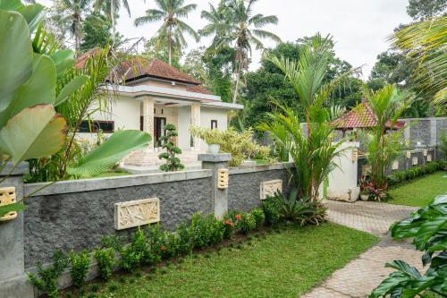 a house in the middle of a garden at Bali Village Villa in Perean
