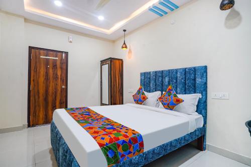 a bedroom with a large bed in a room at FabHotel Grand Broholic - Nr Hitech City in Hyderabad