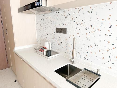 a kitchen with a sink and a white counter top at Ark Seaview Holiday Inn in Sihanoukville