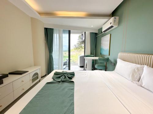 a bedroom with a bed with a bow on it at Ark Seaview Holiday Inn in Sihanoukville