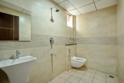 a bathroom with a toilet and a sink at Wandr Scorpious - Manyata tech park in Bangalore