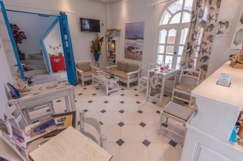 a room with chairs and tables and a mirror at Sofi pension in Naxos Chora