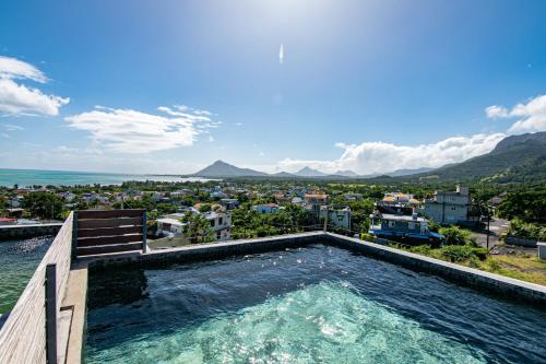 a swimming pool with a view of a city at Laolabatwo in La Gaulette
