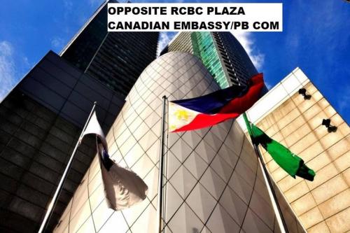 a building with flags in front of a building at Air Residence a2 @Central RCBC/Canadian Embassy in Manila