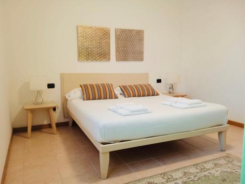 a bedroom with a white bed with two pillows at Residenza Villa in Corno Alto