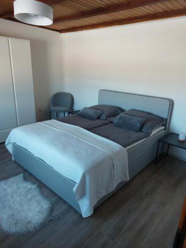 a bedroom with a large bed in a room at Ferienhaus Frankenmarkt in Frankenmarkt