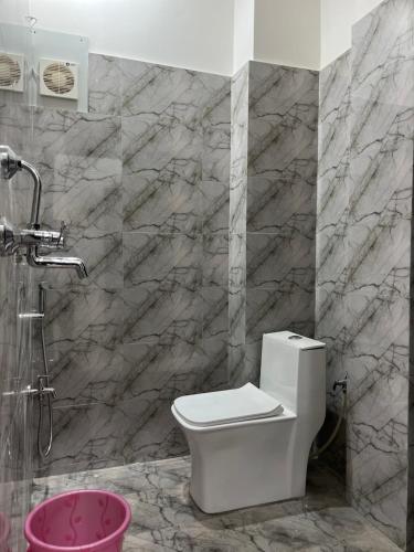 a bathroom with a toilet and a shower at Dhaneshwari Homestay in Varanasi