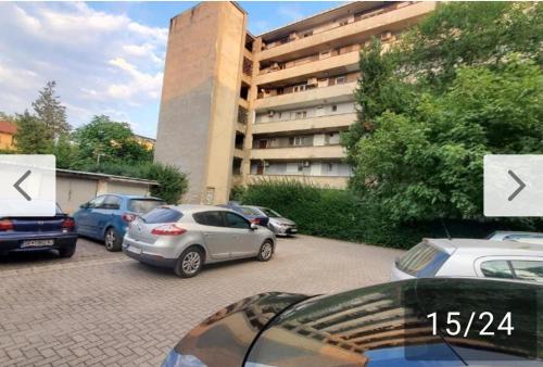 a parking lot with cars parked in front of a building at Aleks 4 in Skopje