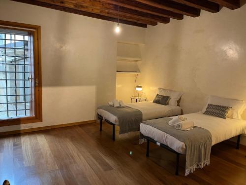 a room with two beds and a window at Il Campanile in Vicenza