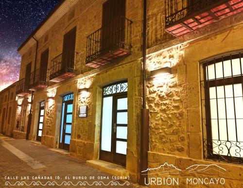 a building with doors and windows at night at Apartamentos LA CAÑADA DE OSMA in El Burgo de Osma