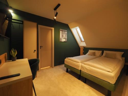 a hotel room with a bed and a desk at Craft Inn - Boutique Hotel in Sibiu