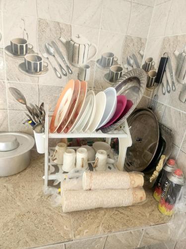 a kitchen counter with a sink and plates and utensils at Sunset view hill jabal shams in Misfāh