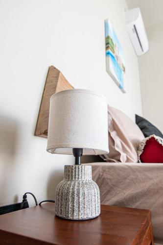 a table with a lamp on top of a bed at Laolabaone in La Gaulette
