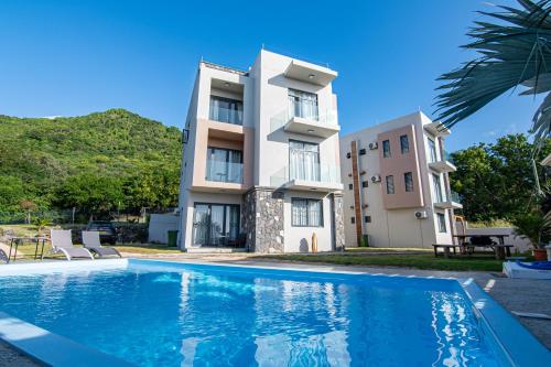 a villa with a swimming pool in front of a building at Laolabaone in La Gaulette
