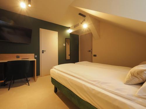 a bedroom with a bed and a desk with a computer at Craft Inn - Boutique Hotel in Sibiu