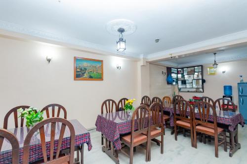 a dining room with a table and chairs at OYO 801 Hotel View Global in Kathmandu