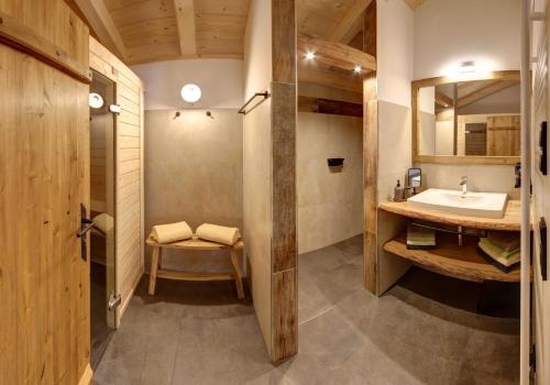 a bathroom with a sink and a mirror at Holznerhof - Chiemgau Karte in Inzell