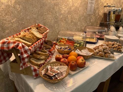 a buffet with bread and other foods on a table at Öreg-tó Hotel és Rendezvénytér in Tata